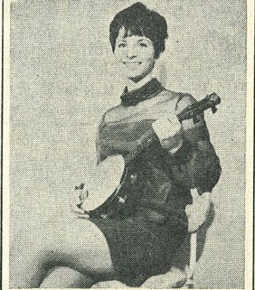 Woman playing banjo-ukulele, described as "member of the Travellers, a Chesterfield folk-singing group" due to play Bradford University Union 1968.